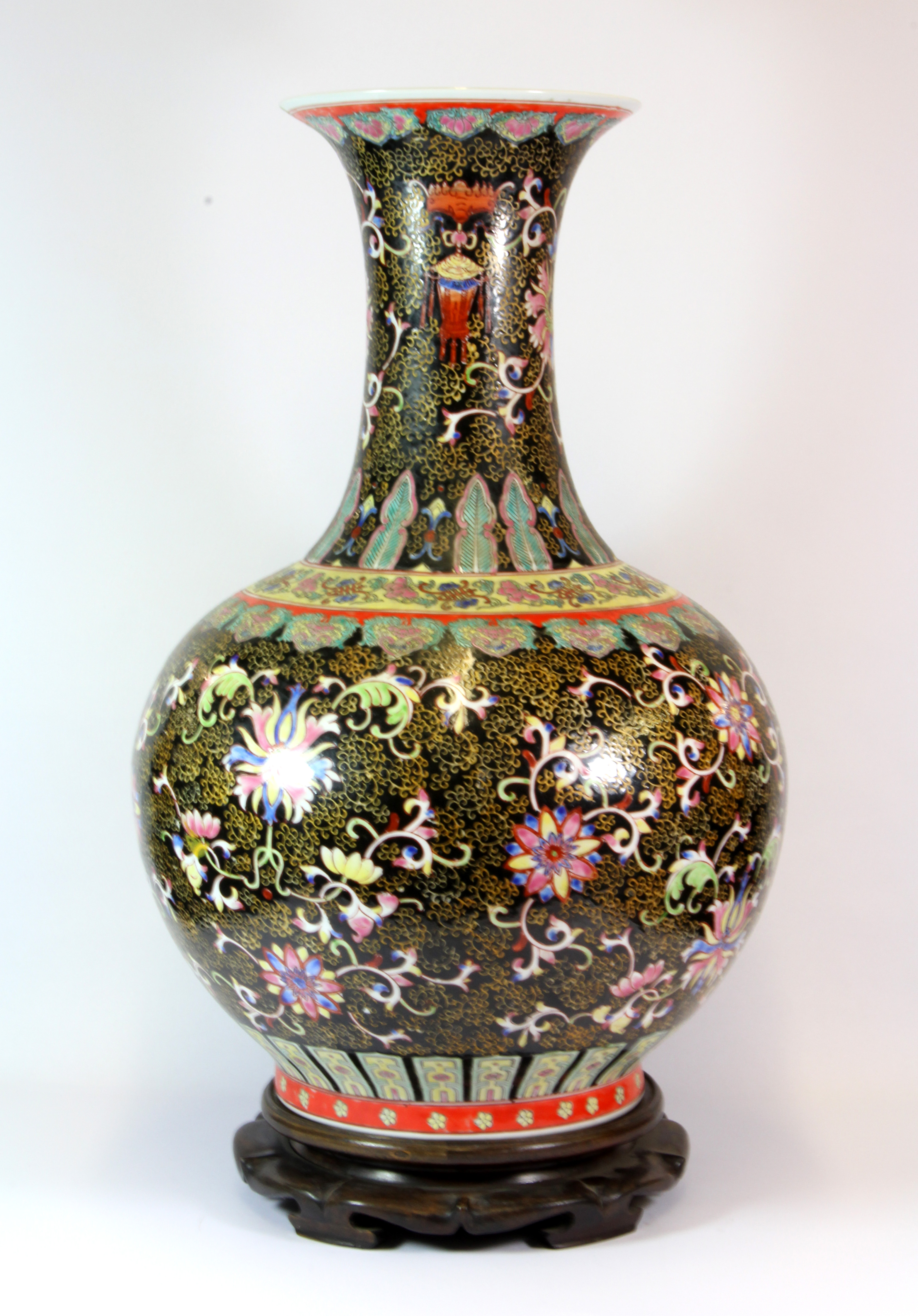 An impressive mid 20th century Chinese hand enamelled porcelain vase with hardwood stand, red four