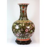 An impressive mid 20th century Chinese hand enamelled porcelain vase with hardwood stand, red four