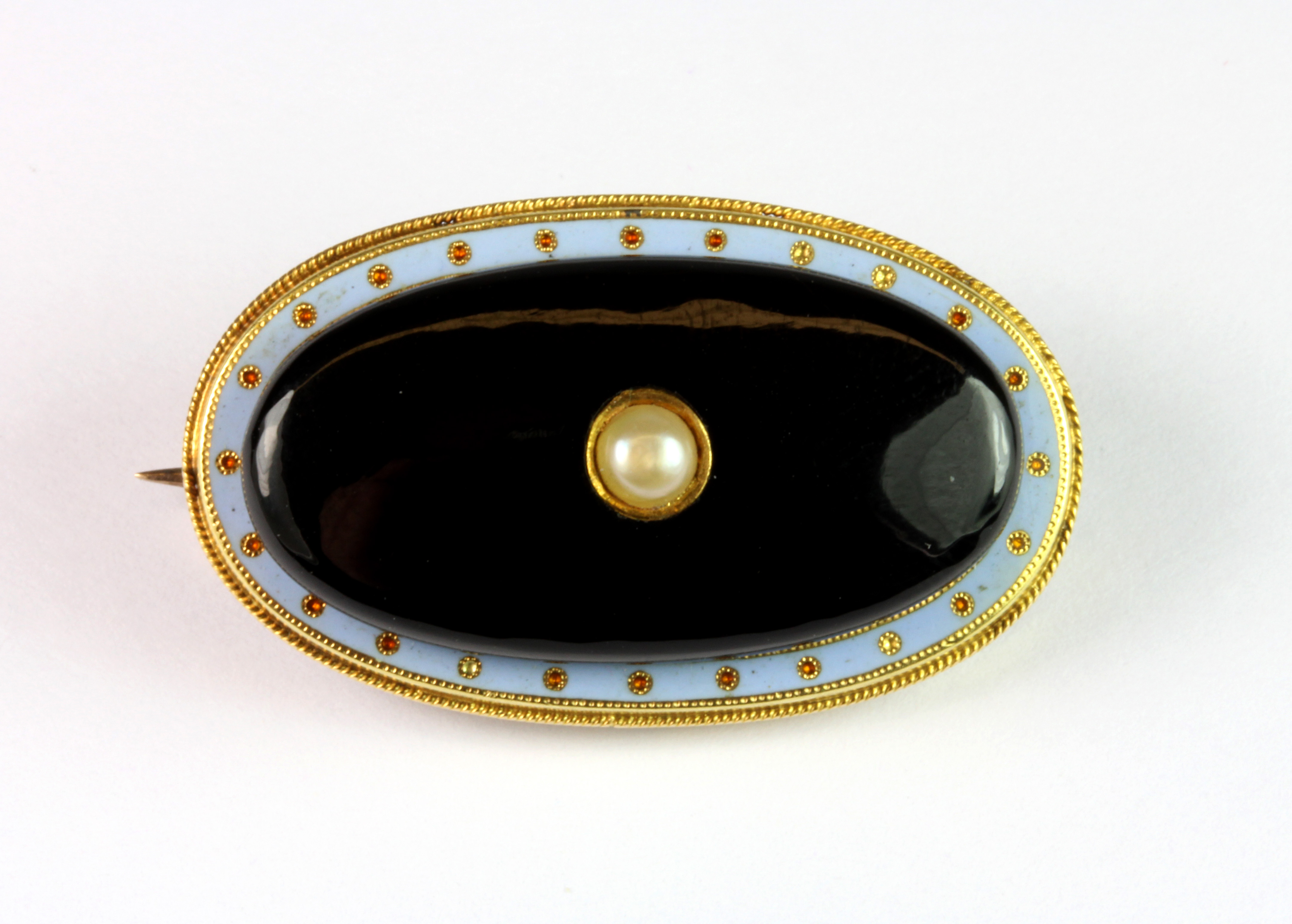 An interesting 9ct yellow gold (stamped 9ct) and enamel onyx and seed pearl set brooch, L. 3.5cm.