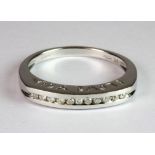 A 9ct white gold (stamped 375) diamond set half eternity ring, with "I LOVE YOU" pierced on the side