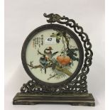 A Chinese decorative circular porcelain panel mounted in a wooden frame. H. 31cms