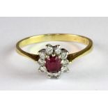An 18ct yellow gold and platinum (worn stamp 18ct & plat) ruby and diamond cluster ring (Q).