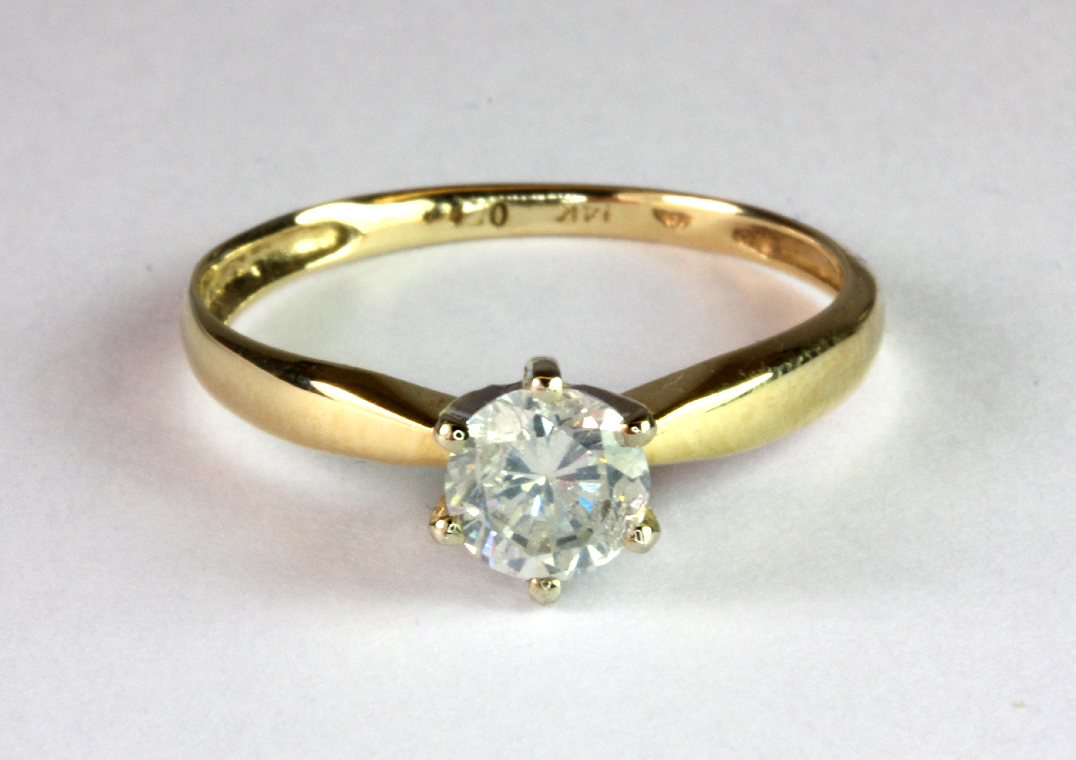 A 14ct yellow gold (stamped 14k) brilliant cut diamond solitaire ring with an antique ring box (