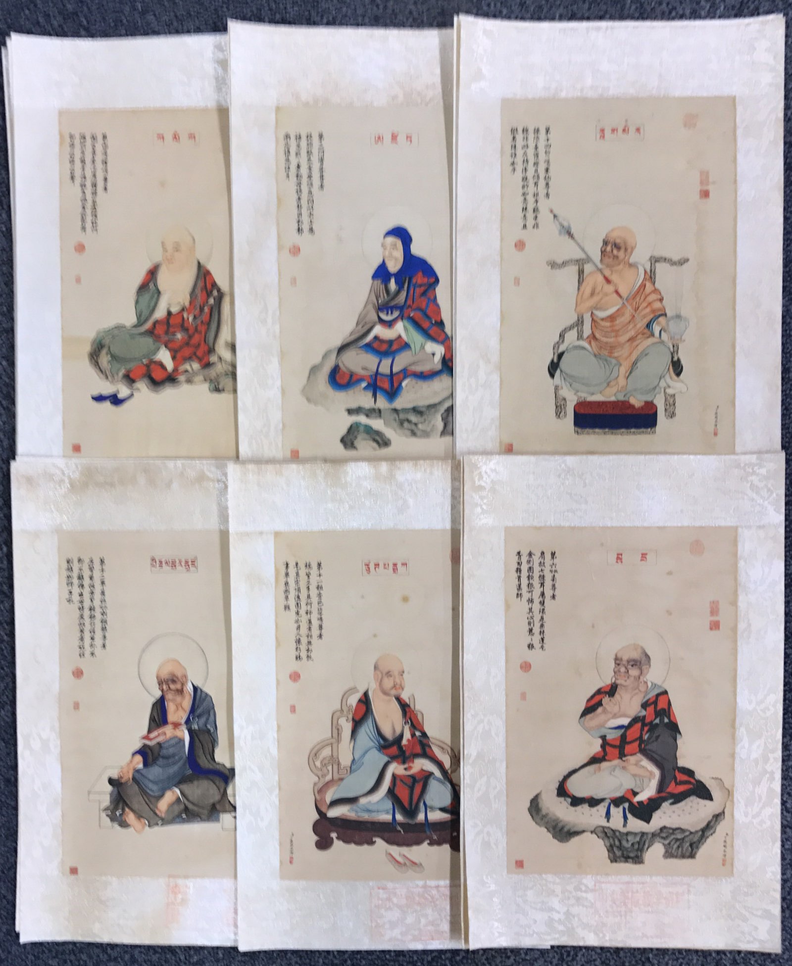 A set of fifteen fine Chinese woodblock style prints, mounted on silk, of Lohan, 27cm x 41cm.