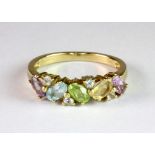 A 9ct yellow gold multi stone set ring (O.5).