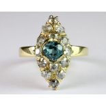 An early 18ct yellow gold (stamped 750) ring set with rose cut diamonds and a natural blue zircon (