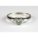 An 18ct white gold (worn stamp 18ct) diamond solitaire ring (J.5).