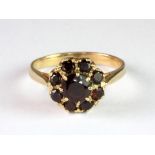A 9ct yellow gold garnet cluster ring (N.5).