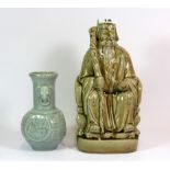 A 20th century Chinese glazed porcelain figure and an incised pottery vase, H. 26cm and 16cm.