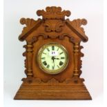 A 19th century oak mantle clock, H. 41cm, understood to be in working order.