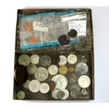 A vintage tin of mixed coins.