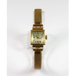 A lady's Rodams 18ct yellow gold wrist watch with a 1/10 9ct gold metal core strap.