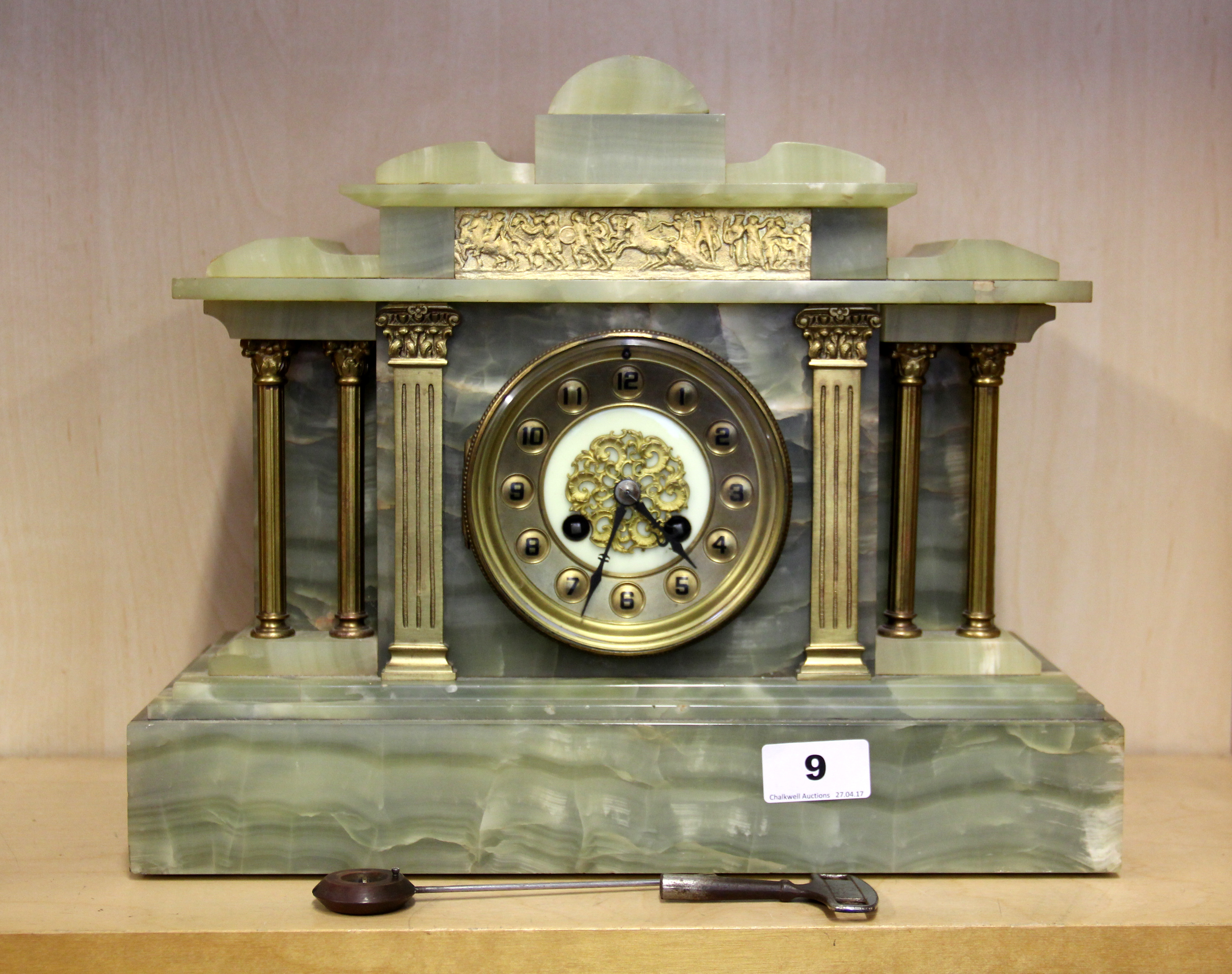 A 19thC French gilt and green onyx mantle clock, H. 30cm, understood to be in working order.