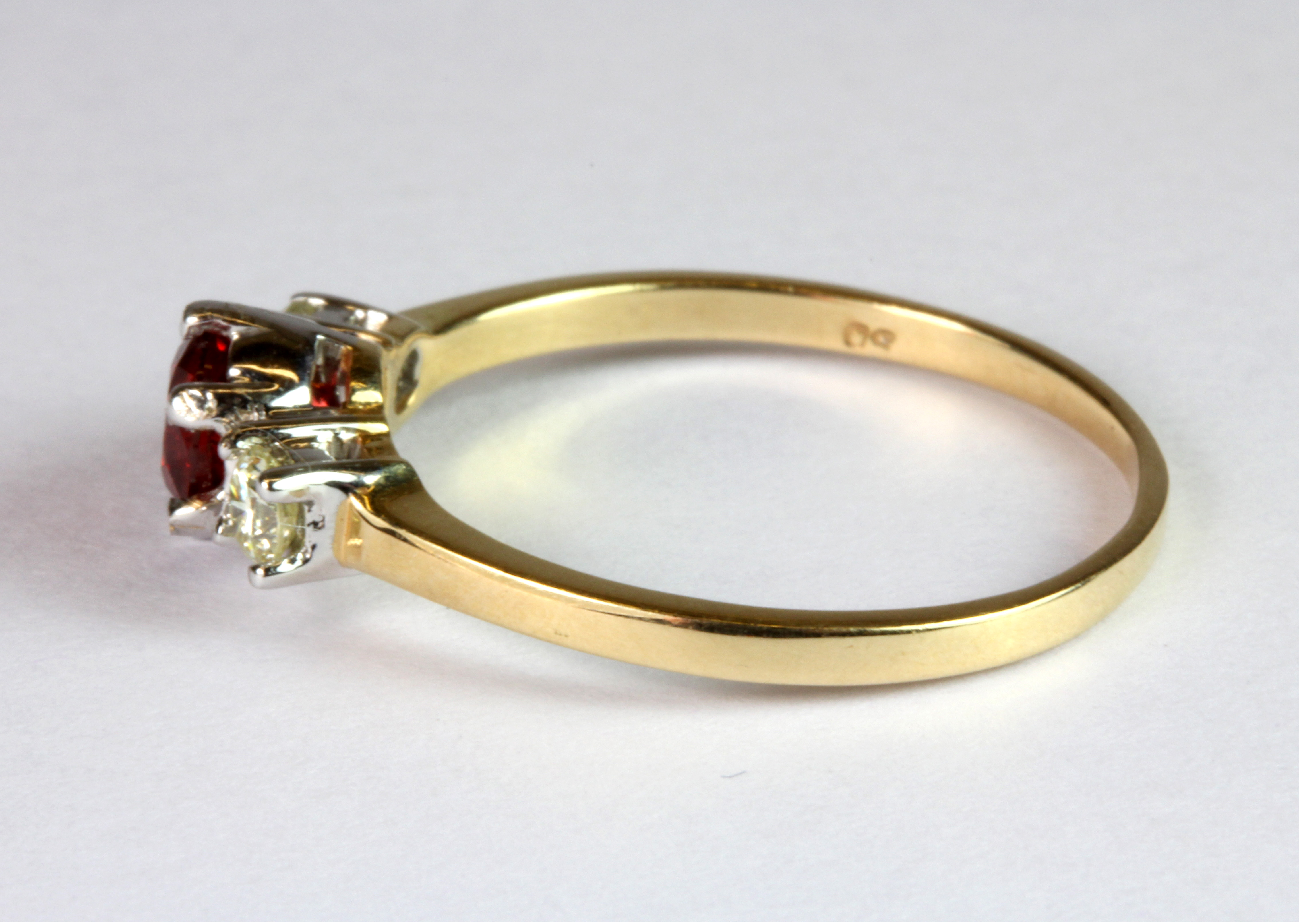 An 18ct yellow and white gold (stamped 18k) ring set with a brilliant cut ruby flanked by - Image 2 of 2