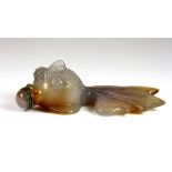 A Chinese carved agate snuff bottle on the shape of a fan tail fish, L. 9cm (minor chip to fin).