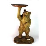 A large carved wooden bear visiting card table, H. 54cm.