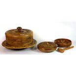 A carved wooden Lazy Susan cheeseboard and cover, nut bowl and a further bowl.