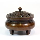 A good quality Chinese bronze censer with pierced lid depicting mandarin ducks among lotus, H. 7.