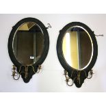 A pair of 19th century oval wall mirrors with green canvas covered wooden frames mounted with gilt