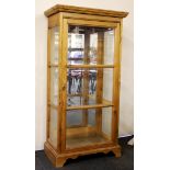 A glazed pine display cabinet, 60cm x 35cm x 125cm.