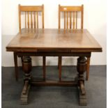 An oak drawer leaf dining table, 92cm x 92cm, together with two chairs.