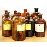 A quantity of amber glass French perfumery bottles, H. 29cm.