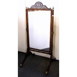 A Regency free standing mahogany mirror, with fretted pediment, H. 147cm.