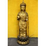 A large Chinese gilt bronze figure of a standing Buddha, H. 102cm.