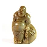 A Chinese carved hardstone pebble seal in the shape of the Happy Buddha, H. 9cm.