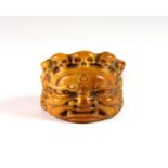A 19th century Tibetan carved yak bone archer's ring decorated with the head of a Buddhist