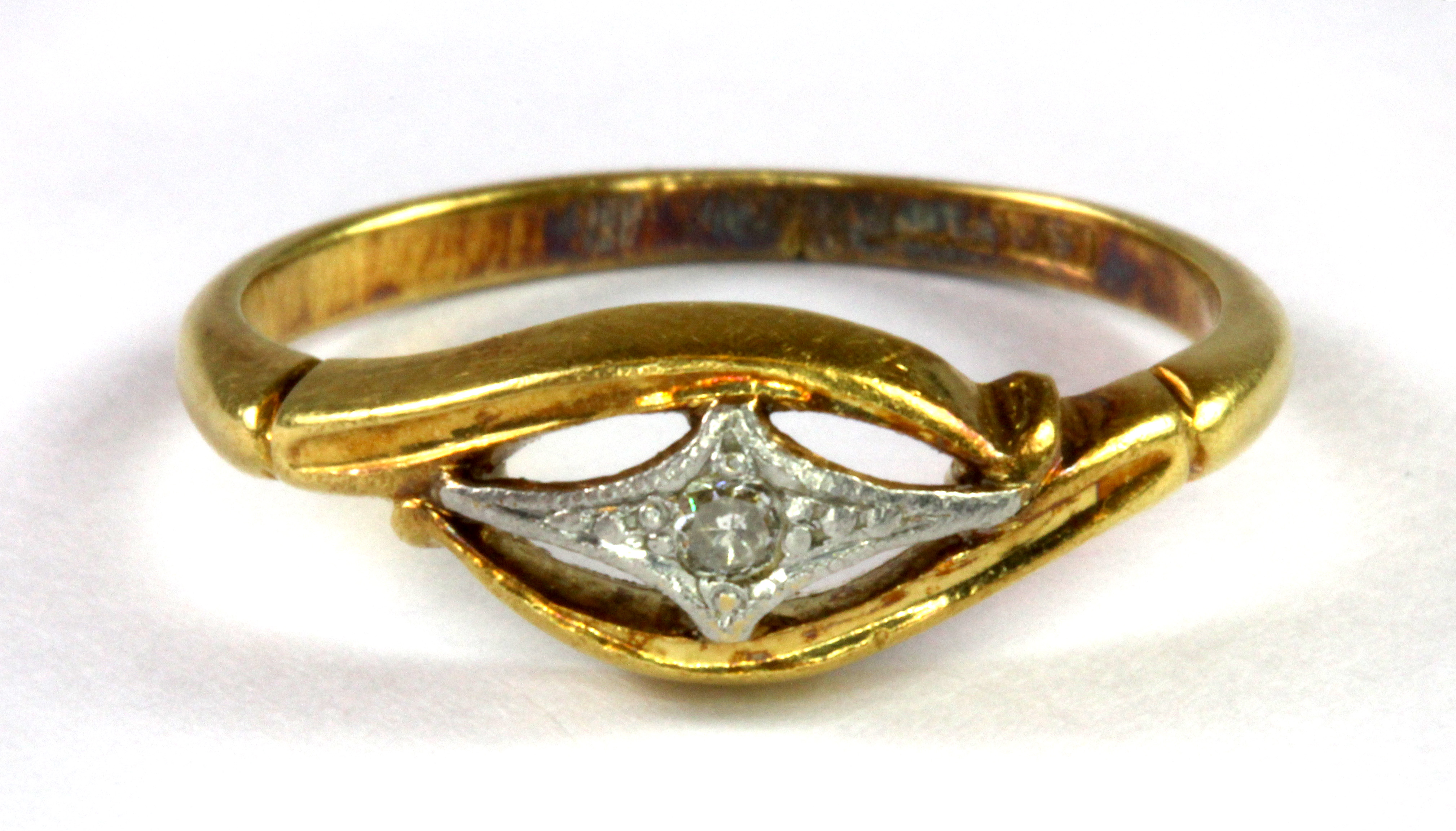 An 18ct yellow and white gold (stamped 18ct) diamond set ring (J.5).