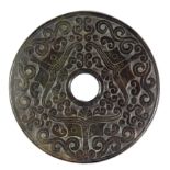 A Chinese mixed colour green and brown carved jade pi disc, Dia. 15cm.