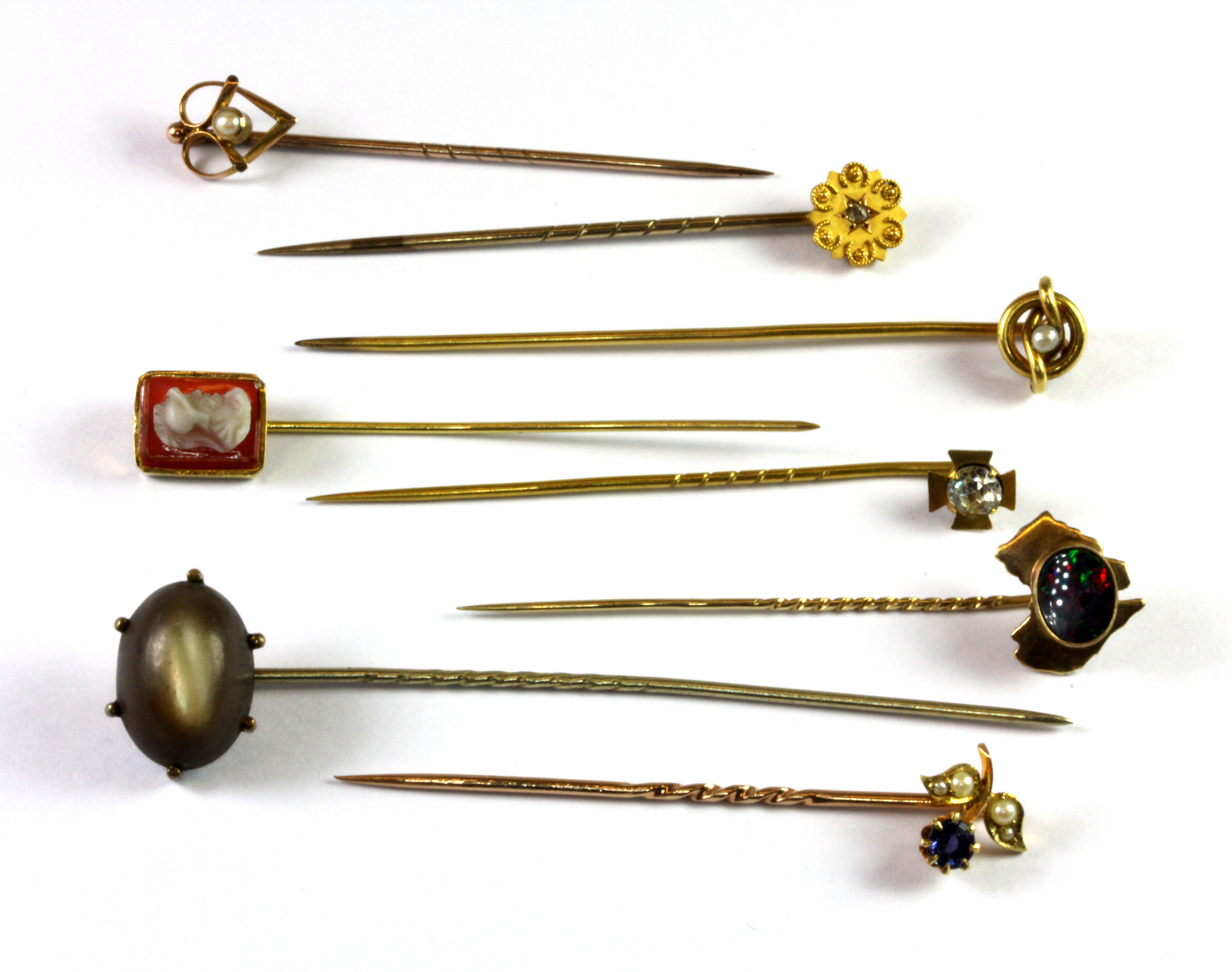 Eight antique 9ct gold diamond and stone set stick pins (approx. 10.5gr overall).