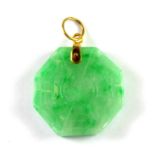 A yellow metal (tested 18ct) mounted carved jade pendant, Dia. 2.3cm.