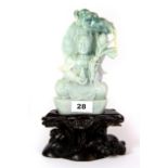 A fine Chinese carved mixed colour jade figure of the Goddess Guan Yin, with carved wooden stand and