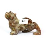 A 19th / early 20th century Chinese carved mixed colour jade / hardstone figure of a tiger, L. 14cm,