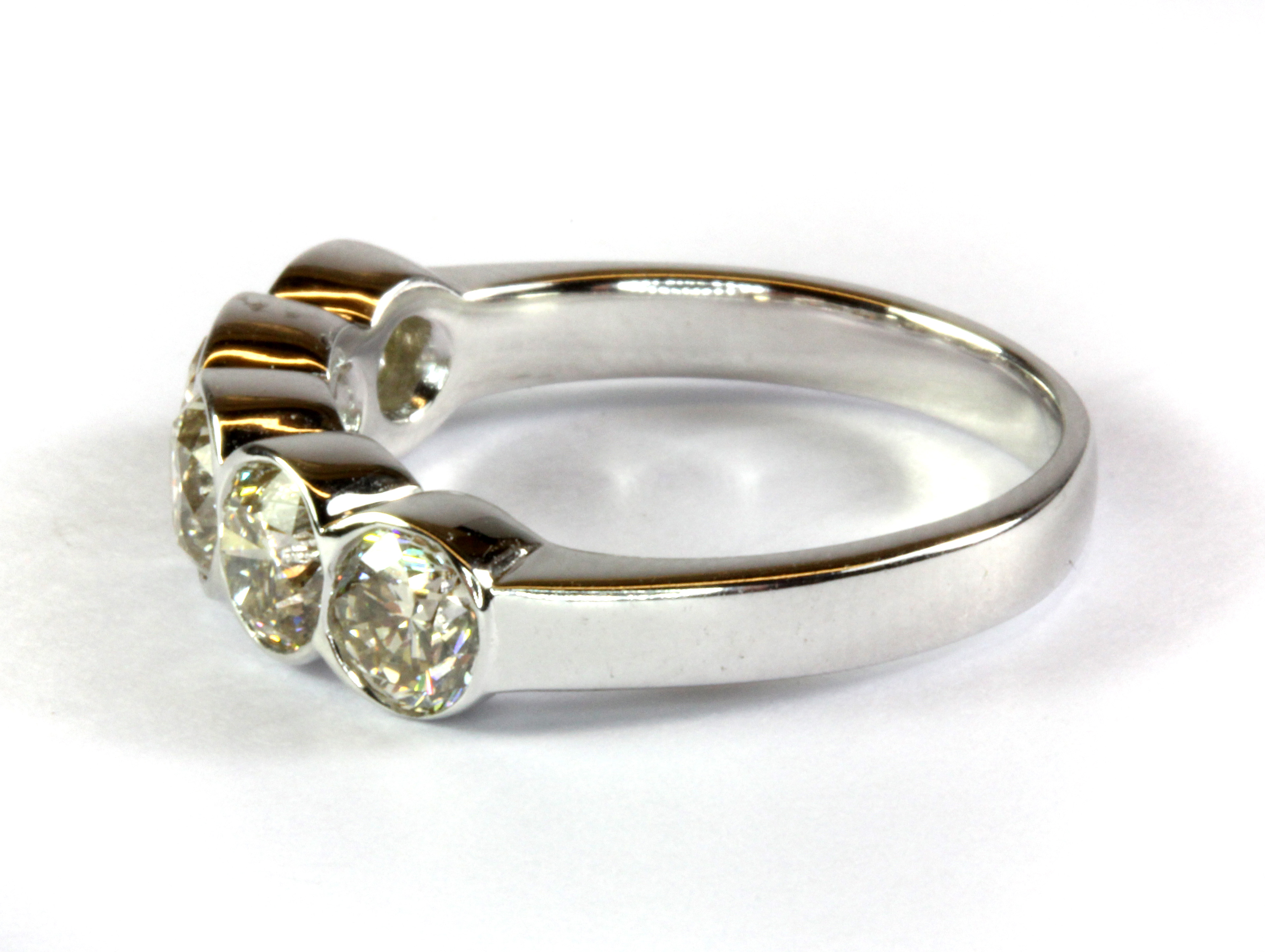 An 18ct white gold ring (stamped 750) set with five brilliant cut diamonds in a rub over setting ( - Image 2 of 2