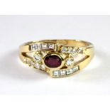 A lovely 18ct yellow gold ring set with an oval cut ruby and diamonds (N.5).