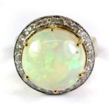 A yellow metal (tested 18ct gold with foreign mark) domed opal and diamond ring (N.5).