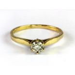 A 9ct yellow gold (worn hallmark) diamond solitaire ring (M).