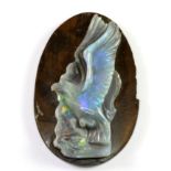 An unusual un-mounted carved blue opal decorated with an eagle. H. 5cms