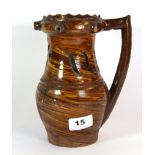 An unusual marbled clay moto jug, H. 20cm.