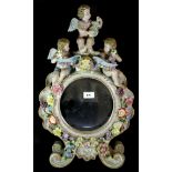 A large German porcelain table mirror decorated with cherubs, H. 57cm.