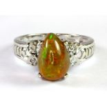 A 9ct white gold ring set with a lovely pear shaped cabochon cut black opal and diamond set