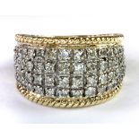 A 9ct yellow and white gold diamond pave set ring (M).