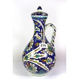 A hand painted pottery ewer and cover with Iznik style decoration, H. 31cm.