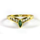 A yellow metal (tested 18ct) emerald and white stone set wishbone ring (O.5).