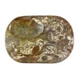 A Chinese carved mixed colour jade / hardstone ink grinding stone decorated with dragons, W. 17cm