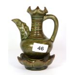 An unusual Chinese green glazed and incised water dropper with integral lotus base, H. 16cm.