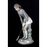 A Lladro figure of a girl playing golf, H. 27cm.